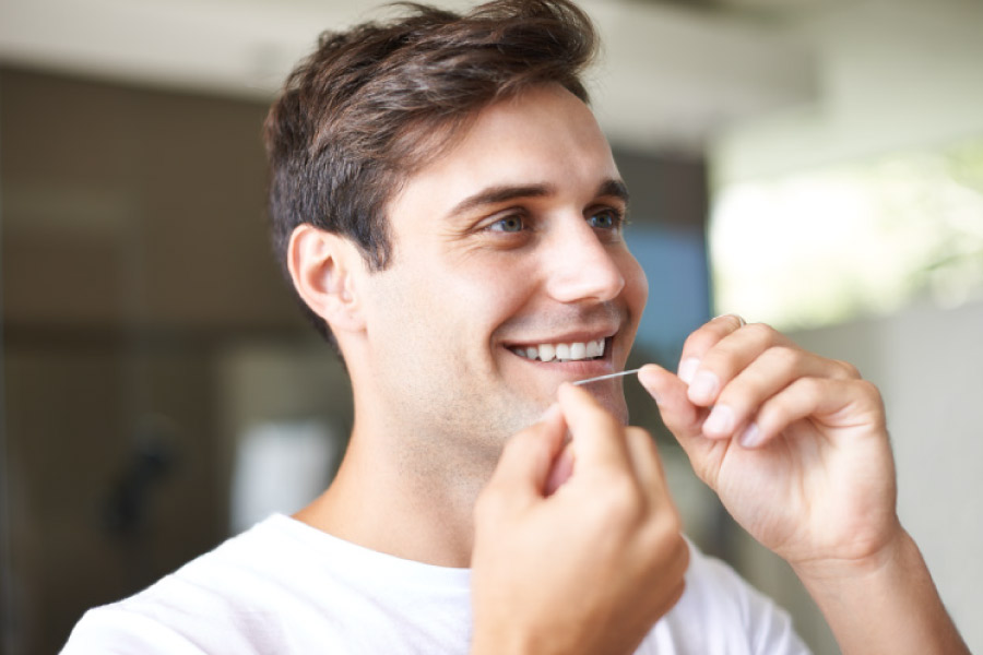 Man flossing his teeth.