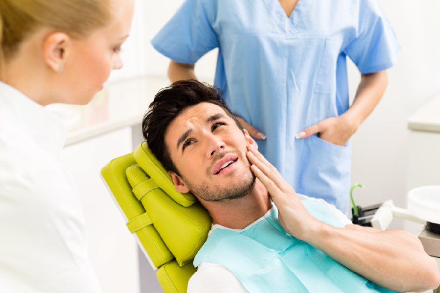 Man in the dental chair with a cracked tooth.