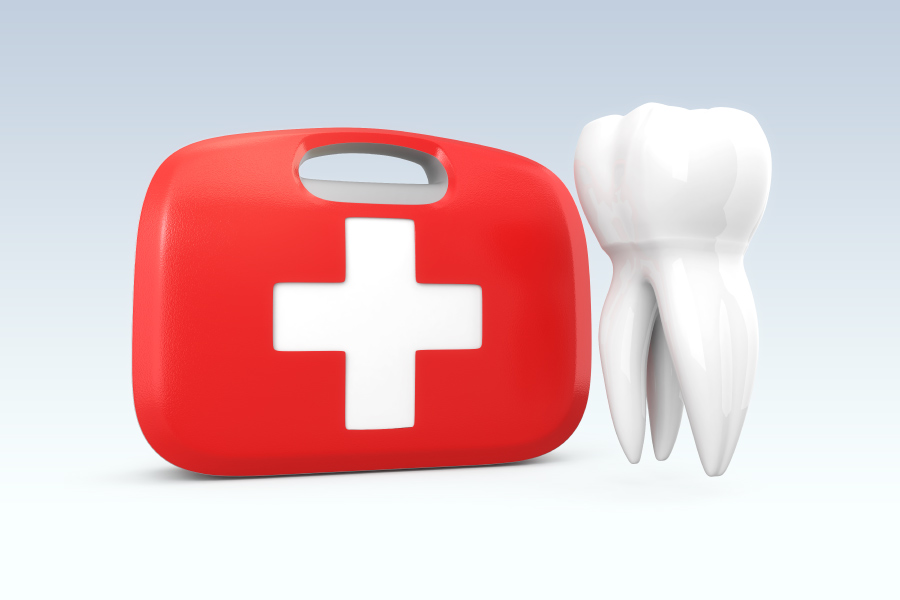 A white tooth floats next to a red and white first aid kit to represent emergency dental care