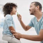 oral care habits, dad brushing child's teeth