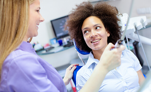 dental staff member preparing to take a digital impression of a patient's teeth