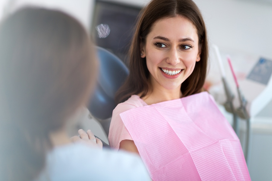 woman in dental chair for new smile with cosmetic dentistry and restorative dentistry