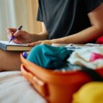 woman packing for a trip, travel dental kit