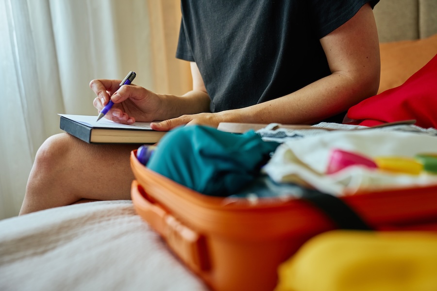 woman packing for a trip, travel dental kit